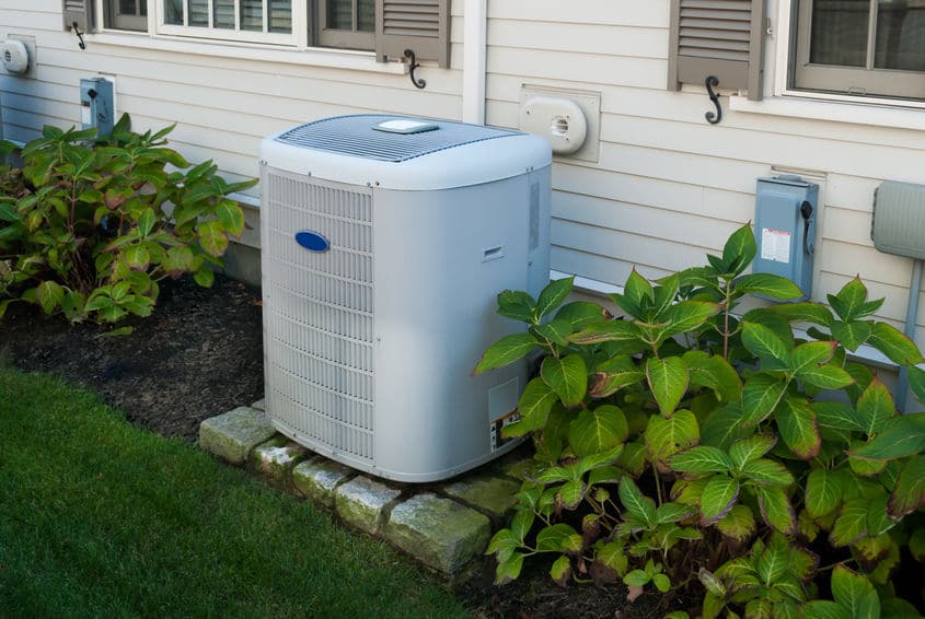 a silver outdoor AC system next to a Louisiana home