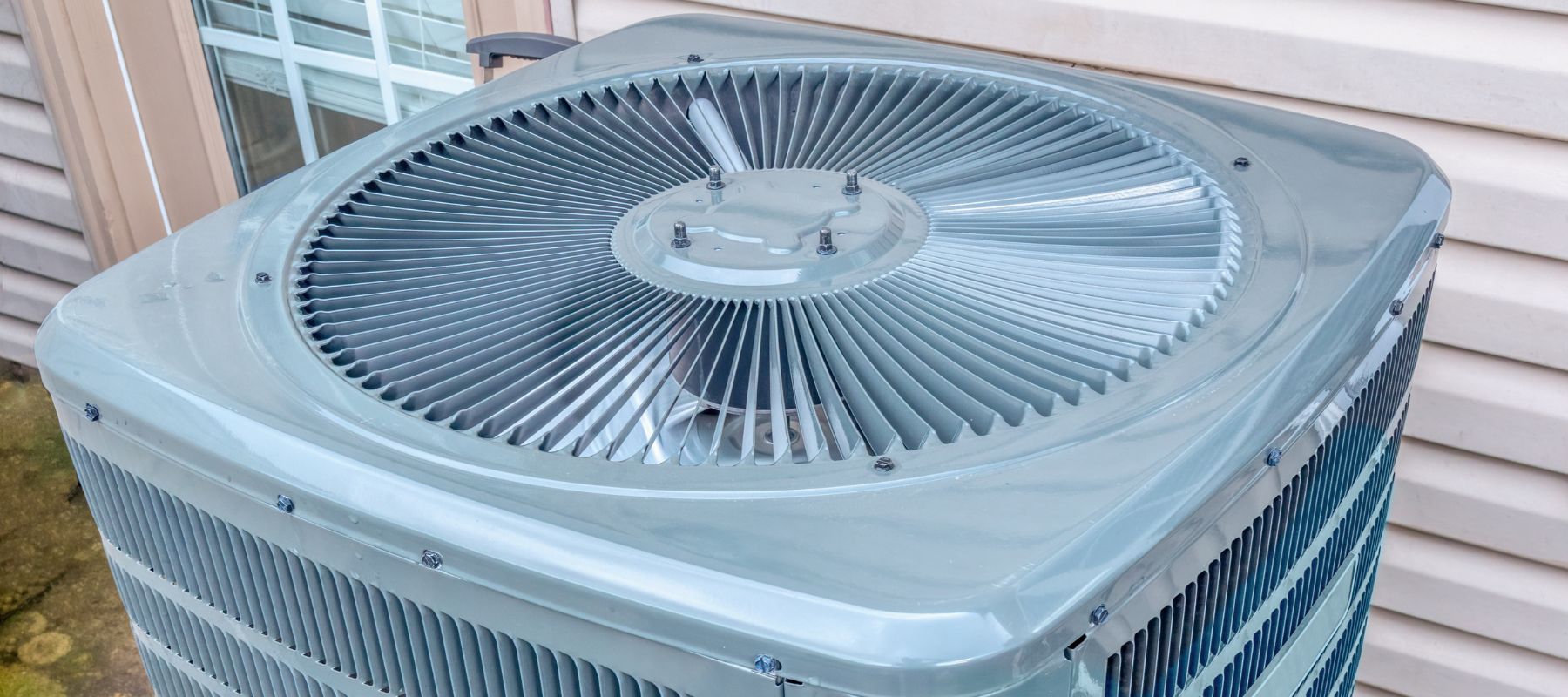 closeup of the top of an outdoor hvac unit fan